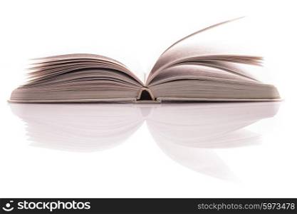 One open white book with reflection on white. White open book