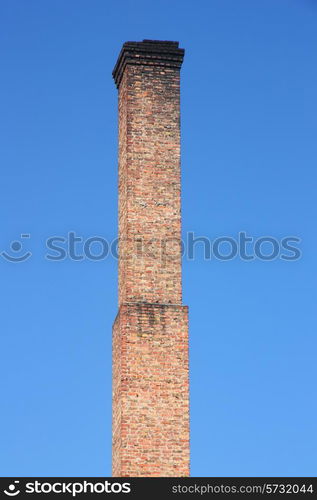 one orange brick pipe on blue sky. environmental construction concept