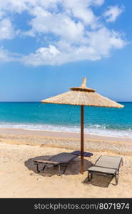 One parasol and sun beds and parasol at sea