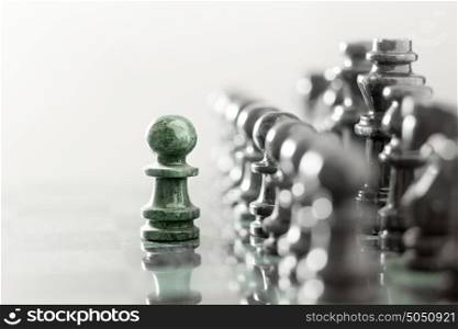 One pawn staying against full set of chess pieces.
