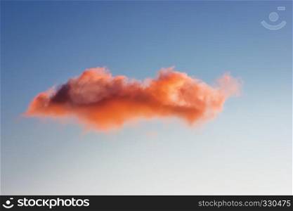 One pink orange cloud in the blue sky.. Single cloud in the sky