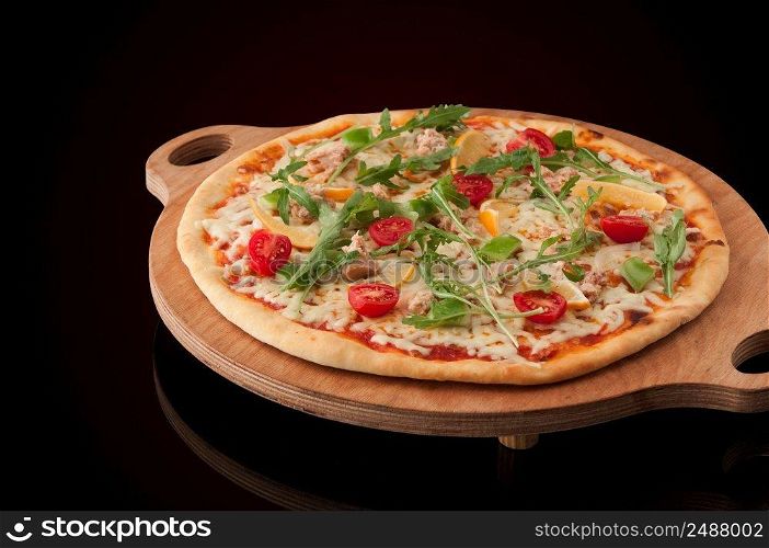 one pizza on a wooden tray. pizza on a wooden tray