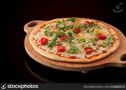 one pizza on a wooden tray. pizza on a wooden tray