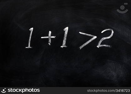 One plus one is greater than two written on a blackboard