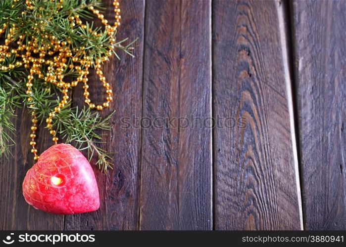 One red candle on the wooden table