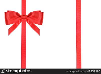 one red satin bow in upper left corner and two vertical ribbons isolated on horizontal white background