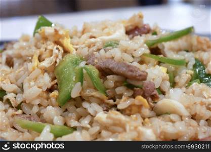 One side of fried rice on table inside restaurant