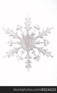 One silvery snowflake on a white background. Winter figures