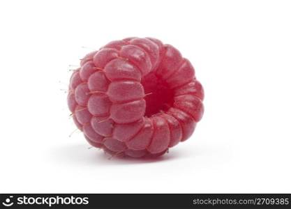 One single whole raspberry on white background