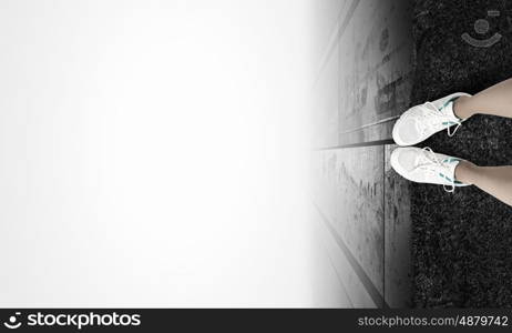 One step to gap. Woman standing on the edge of the roof