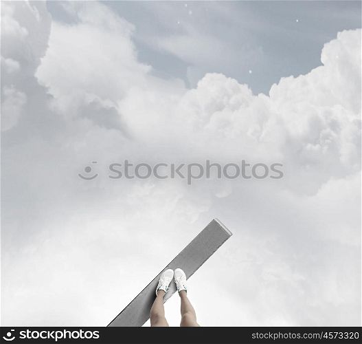 One step to gap. Woman standing on the edge of wooden board