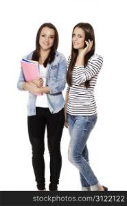 one student calling by phone near her friend with notepads. one student calling by phone near her friend with notepads on white background