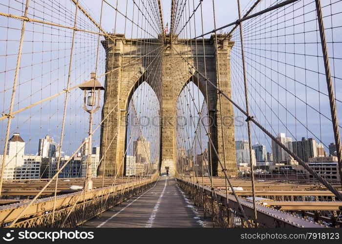 One tower of the Brooklyn Bridge and the pedestrian walkway on a crisp, cold day in February in New York City.