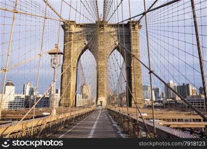 One tower of the Brooklyn Bridge and the pedestrian walkway on a crisp, cold day in February in New York City.