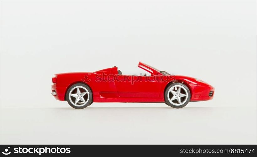One toy car, red sportscar, isolated on white