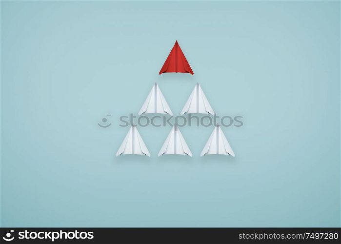One unique red paper airplane lead the group of white paper airplane on light blue background . Business or design creative ideal leadership concept .