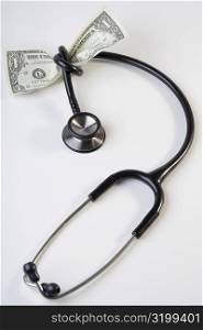 One US dollar bill tied up with a stethoscope