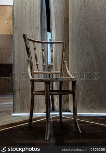 One vintage wooden chair design standing front of wooden wall at area room. Space for text, Focus and blur.