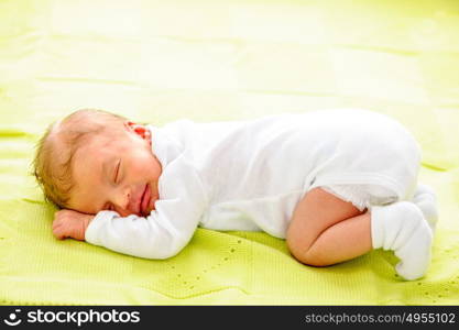 One week old newborn baby on blanket