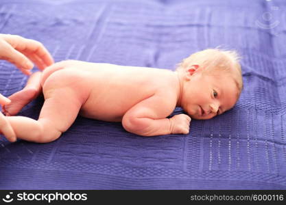 One week old newborn baby on blanket