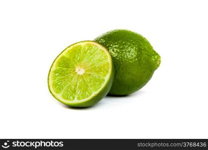 One whole lime and one half lime isolated on a white background