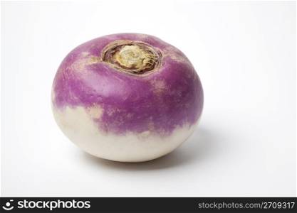 One whole purple headed turnip on white background