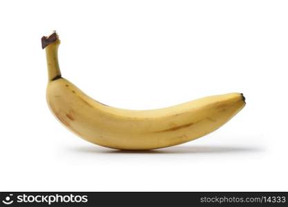 One whole unpeeled banana on white background