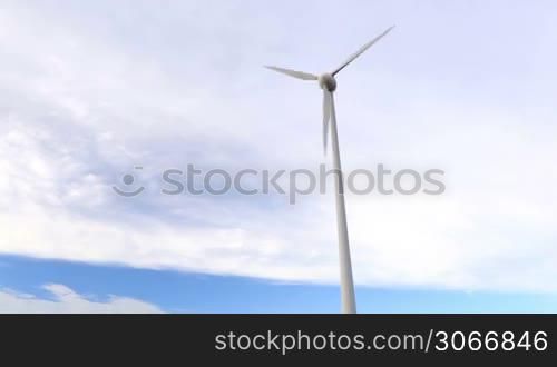 One wind turbine over the blue sky with clouds. Wide shot, low angle.