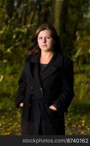 One Woman outdoors wearing black coat autumn park
