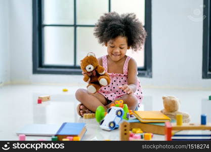 One young African girls play toys and look fun and enjoy.