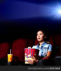 One young girl watching movie in cinema