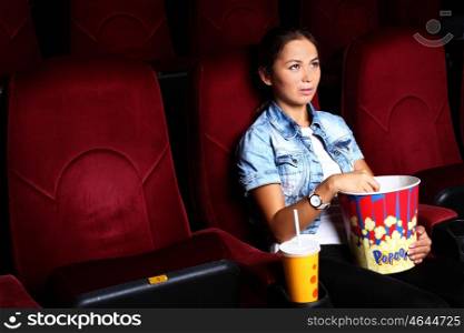 One young girl watching movie in cinema