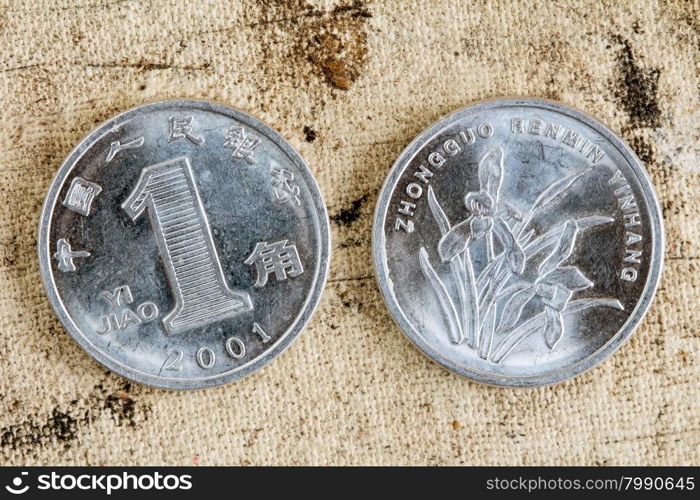 One yuan 2011 coin chinese money, on a old canvas background