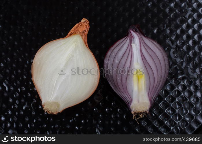 Onion bulb cut in half on a background