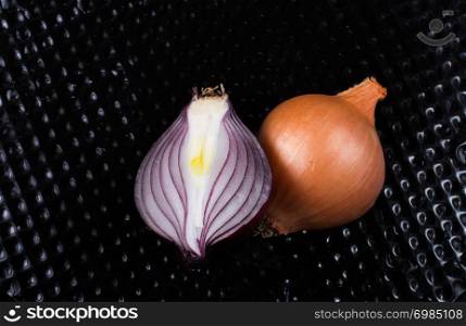 Onion bulb cut in half on a background