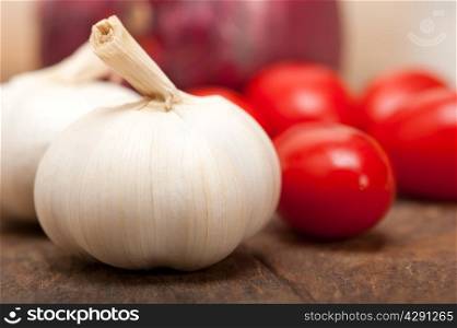 onion garlic and tomatoes foundations of Italian food on rustic table