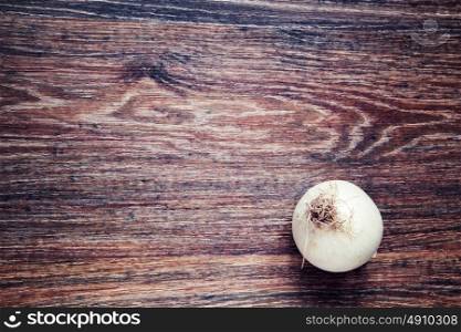 onion on wood. Top View on wooden table with Copy Space. Ingredients for cooking