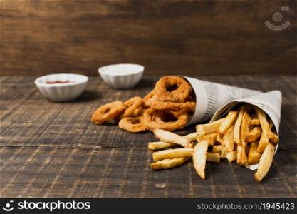 onion rings fries wooden table. High resolution photo. onion rings fries wooden table. High quality photo