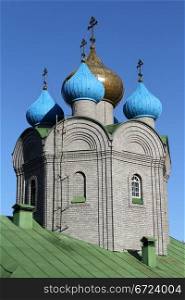 Onion shape cupola and green roof of new russian church in Murmansk, Russia