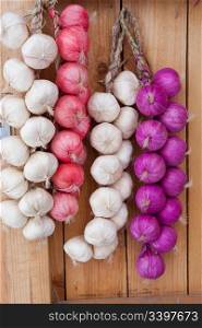 Onions hanging on a door frame.