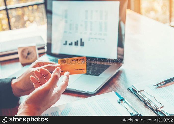 Online banking businessman using Laptop with credit card online shopping in cafe, Fintech and Blockchain concept stock