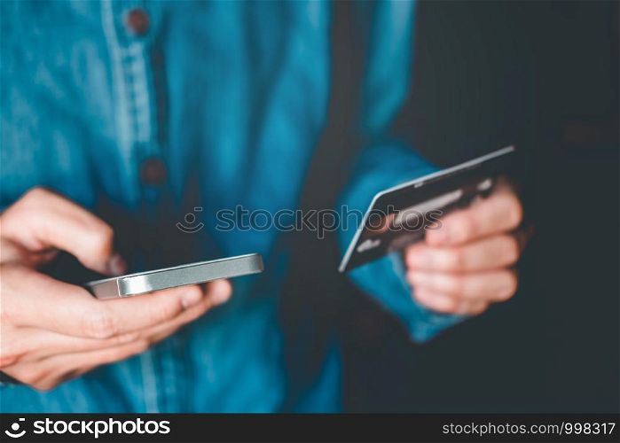Online banking businessman using smartphone with credit card Fintech and Blockchain concept