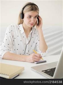 online classes with student holding her headphones