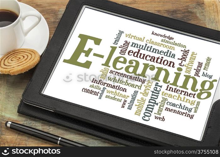 online education concept - e-learning word cloud on a digital tablet with a cup of coffee
