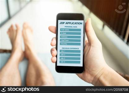 Online job application with mobile. Man filling up online job application on phone screen. Jobless seeker, recruitment, job search online Concept.