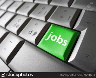 Online job search concept with jobs sign and symbol on a green laptop computer key for website and online business.