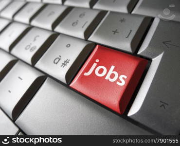 Online job search concept with jobs sign and symbol on a red laptop computer key for website and online business.