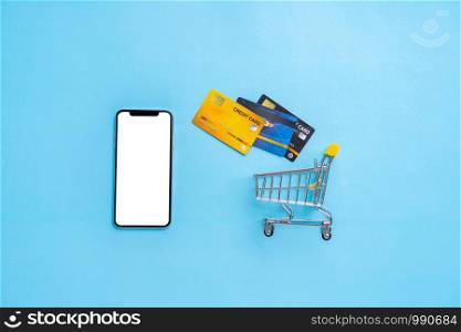Online payment concept with shopping cart top view