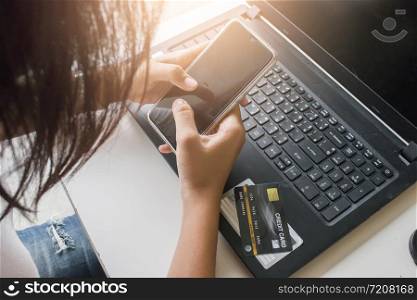 Online payment,Woman&rsquo;s hands holding smartphone and using credit card for online shopping.