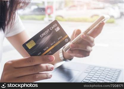 Online payment,Women hands holding smartphone and using credit card for online shopping.